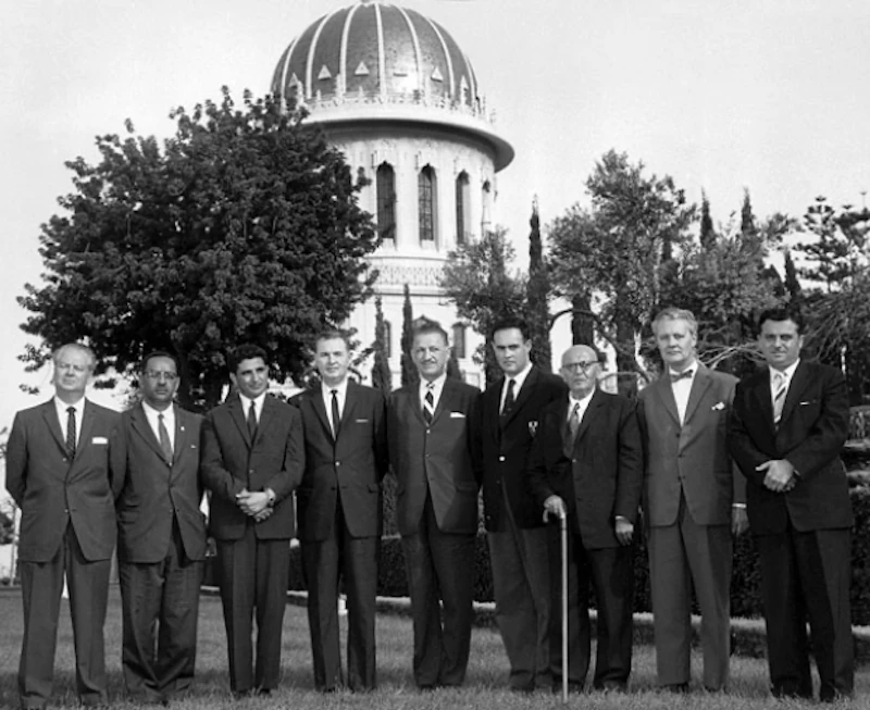 First nine members of the Universal House of Justice standing