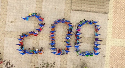 Aerial view of children and youth united in movement